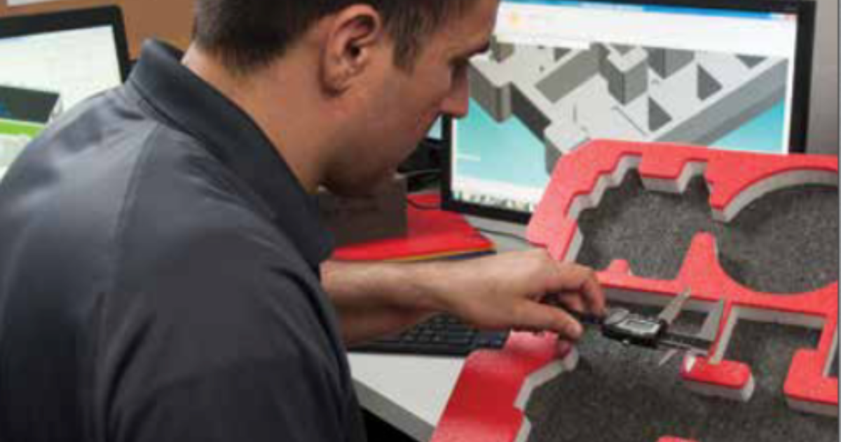Engineer inspecting a 3D-printed part with calipers.
